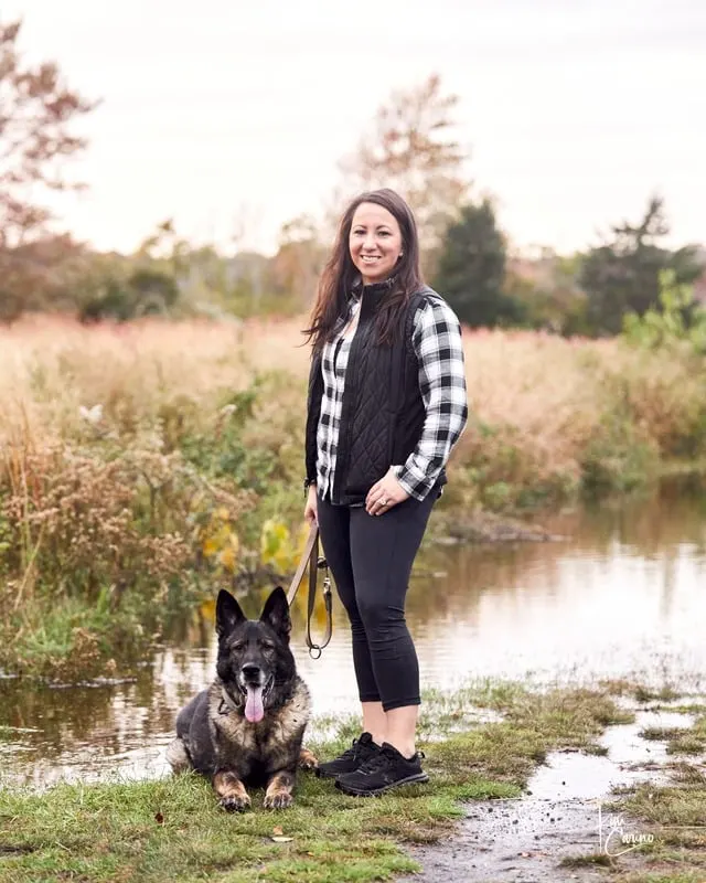 Shannon Miller with her German Shepherd on the Connecticut shoreline